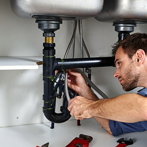 burlington plumber working on a broken sink drain